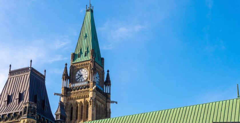 Parliament building in Ottawa, Canada, with Canadian flag.